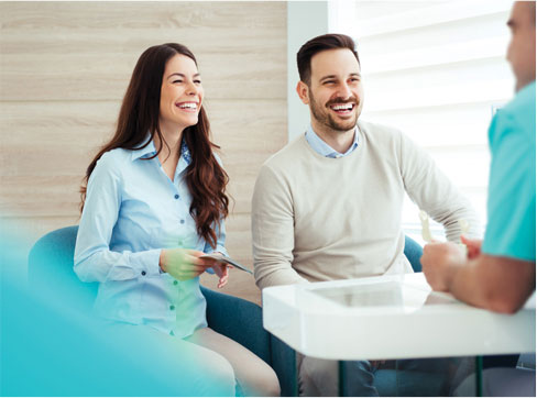Two people talking to a nurse